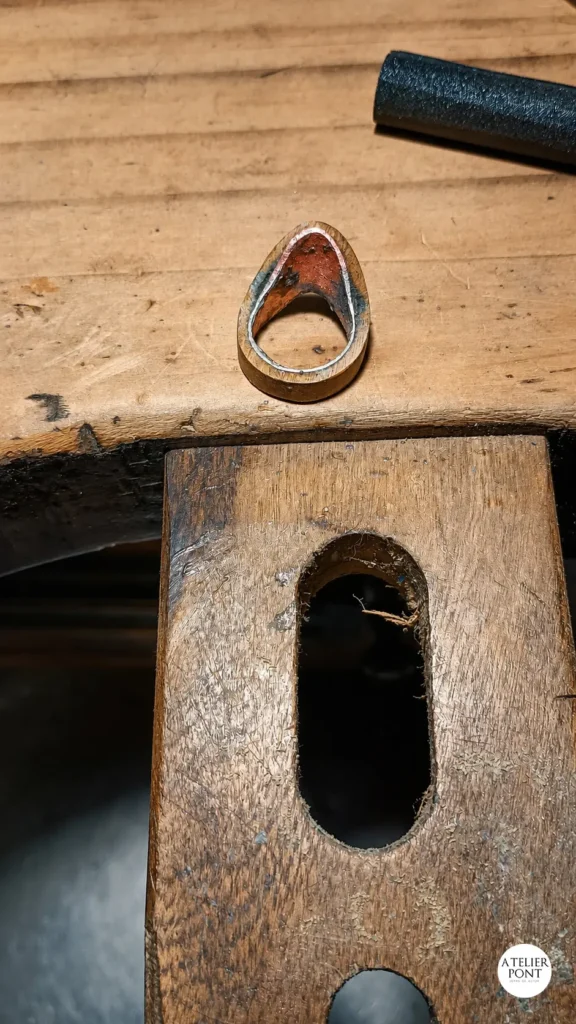 Momento en que la estructura de cobre reciclado se integra con la pieza de madera, formando el cuerpo definitivo del anillo.